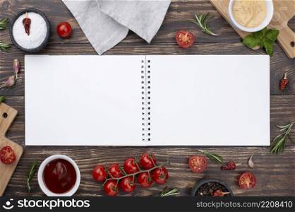 opened notebook with ingredients beside table