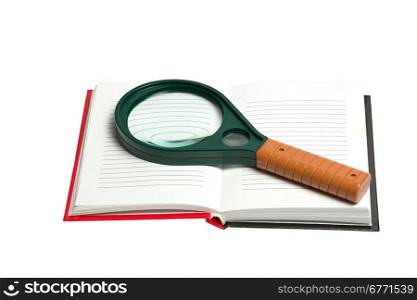 Opened notepad with magnifying glass isolated on white background, studio shot; high depth of field