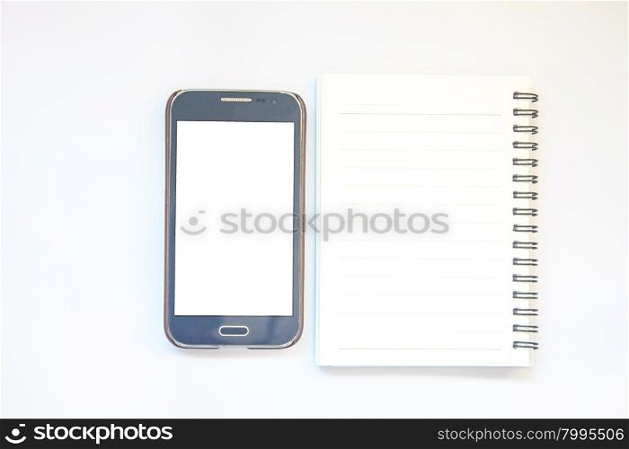 Opened notepad with smart phone on white background