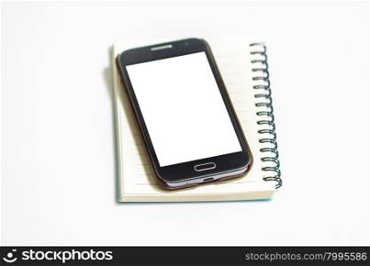 Opened notepad with smart phone on white background