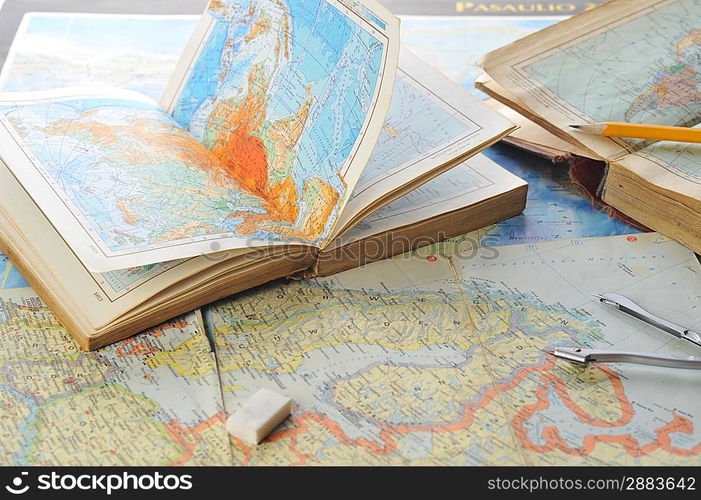 opened old atlas book on map and pensil