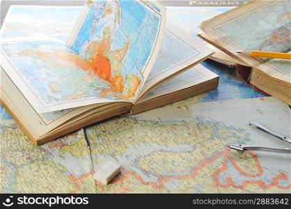 opened old atlas book on map and pensil