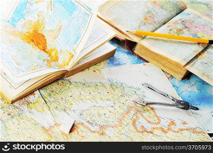 opened old atlas book on map and pensil