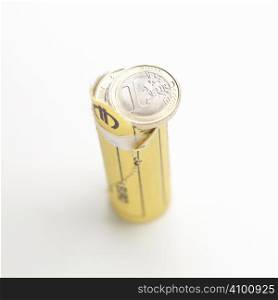 Opened roll of euro coins on white