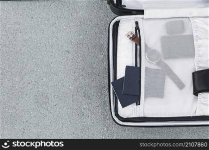 opened suitcase with passports watch