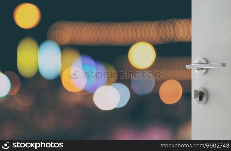 opened white door to abstract background with bokeh defocused lights and shadow from cityscape at night
