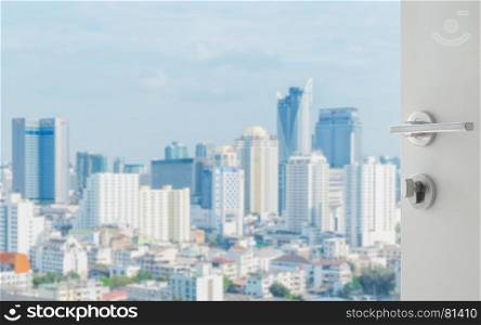 opened white door to bangkok city skyline with modern buidings as background