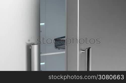 Opening and closing the door of an empty fridge