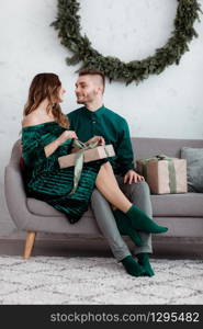 Opening christmas present. Couple in love happy enjoy christmas holiday celebration. Loving couple cuddle smiling while unpacking gift christmas tree background.What a surprise. Opening christmas present. Couple in love happy enjoy christmas holiday celebration. Loving couple cuddle smiling while unpacking gift christmas tree background.What a surprise.