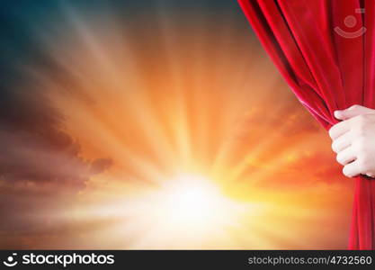 Opening curtain. Close up of hand opening red curtain. Place for text