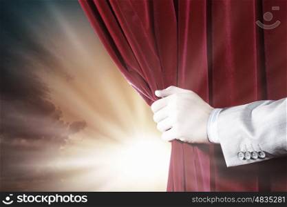 Opening curtain. Close up of hand opening red curtain. Place for text