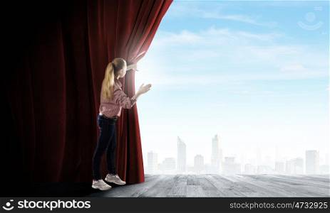 Opening curtain. Young woman in casual opening red curtain