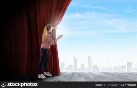 Opening curtain. Young woman in casual opening red curtain