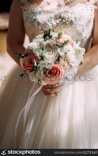 Openwork dress with a bouquet of flowers.. A bride in a futuristic wedding dress holds a bouquet 3909.