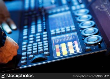 Operator working with lighting control console. Selective focus.
