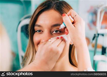 Ophthalmologist applying eyedrops