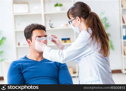 Ophthalmologist is checking up patient in eye doctor hospital