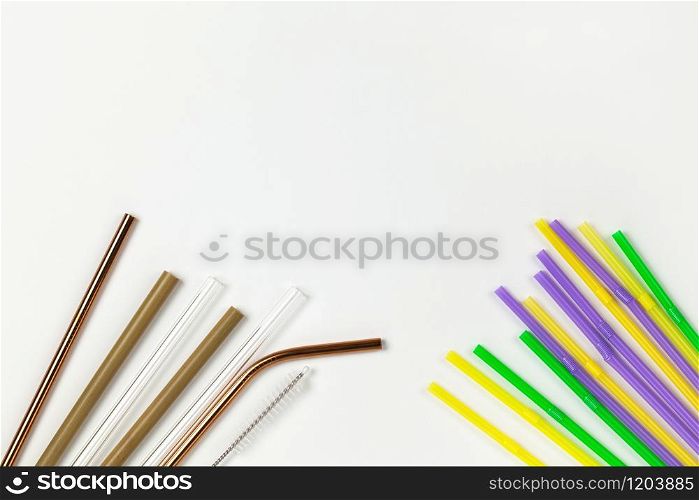 Opposition of plastic disposable tubes and environmental metal, glass, bamboo. Alternative to disposable tableware concept. White background. Horizontal. Copy space. Flat lay, close-up, top veiw.