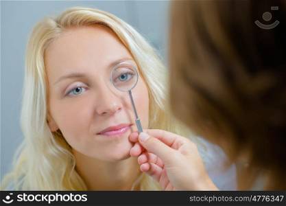 Optician checking a woman's eye