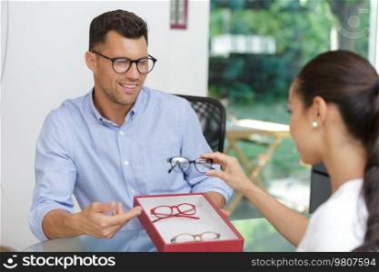 optician suggesting frames for patient to try