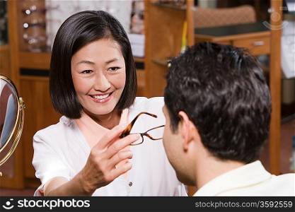 Optician with customer in store