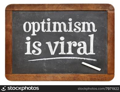optimism is viral - white chalk text on a vintage slate blackboard
