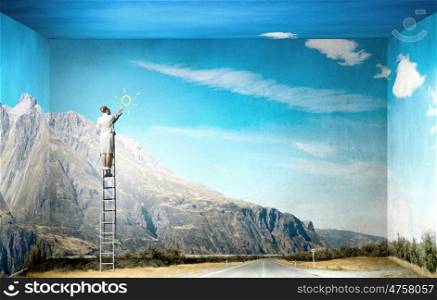 Optimistic approach. Businesswoman standing on ladder drawing sun on wall
