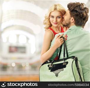 Optimistic couple spending leisure in a shopping mall