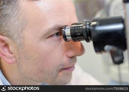 optometrist performing visual field test
