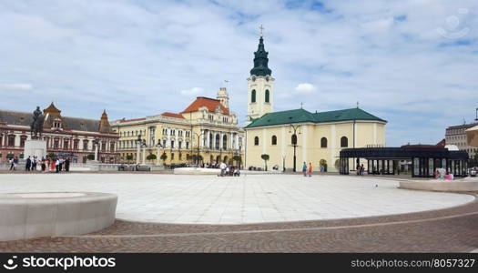 ORADEA, ROMANIA - 08.14.2016: Union square and Roman Catholic Church landmark architecture