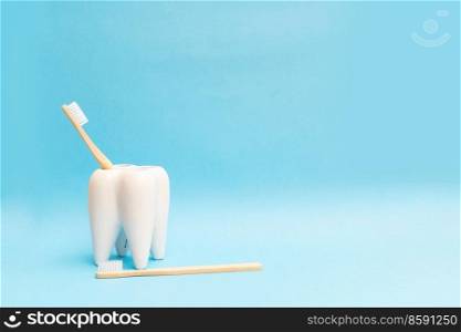 Oral care and dental heakth concept - tooth with toothbrushes over blue background. Oral care concept