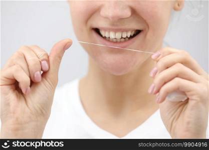Oral hygiene and health care. Smiling woman use dental floss white healthy teeth. Oral hygiene and health care. Smiling woman use dental floss white healthy teeth.