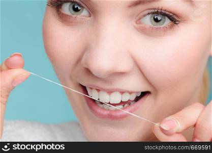 Oral hygiene and health care. Smiling women use dental floss white healthy teeth.. Woman face smiling with dental floss.