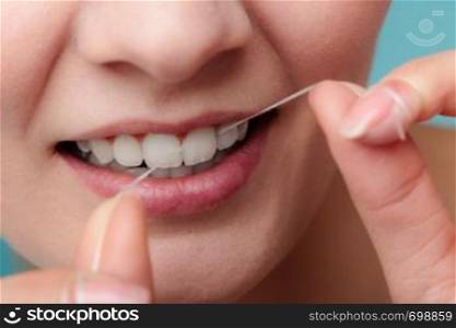 Oral hygiene and health care. Smiling women use dental floss white healthy teeth.. Woman smiling with dental floss.