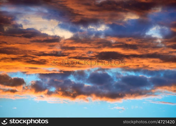 Orange and blue dramatic sky with clouds at sunset