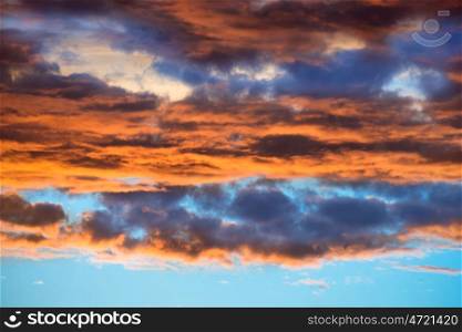 Orange and blue dramatic sky with clouds at sunset