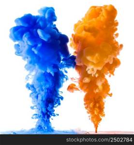 Orange and blue ink splashes in the water, isolated on white background