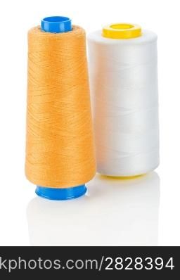 orange and white thread on spools isolated