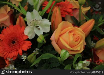Orange and white wedding bouquet with various flowers