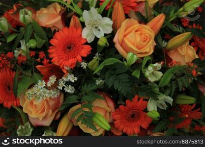 Orange and white wedding bouquet with various flowers