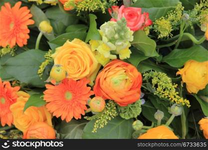 orange and yellow roses and gerberas in a spring bouquet