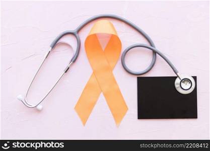 orange awareness ribbons with stethoscope slate pink background