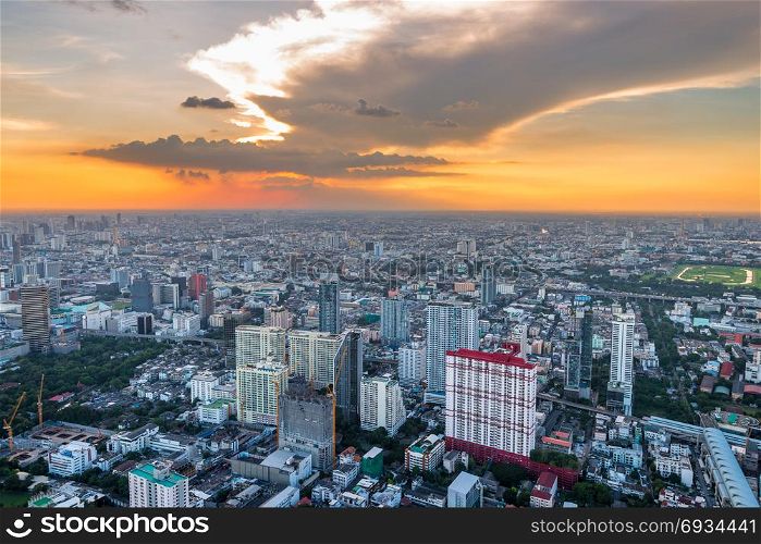 orange beautiful sunset over the big metropolis capital of Thailand, view of Bangkok from the skyscraper