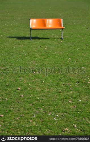 Orange bench on lawn