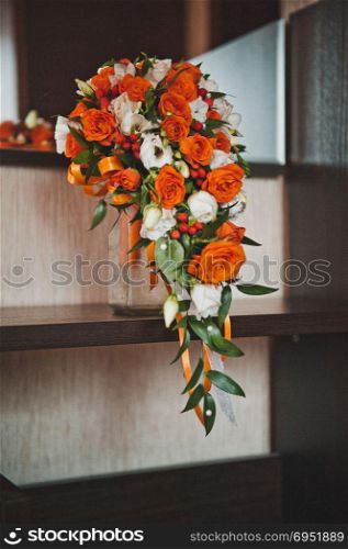Orange bouquet from the flowers interwoven into it.. Wedding bouquet from bright flowers 1959.