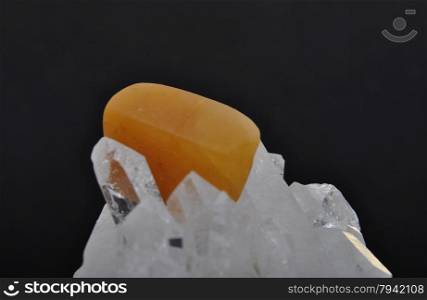 Orange calcite on rock crystal