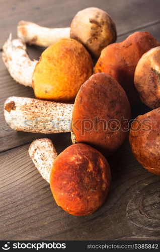 Orange-cap boletus mushrooms on the wooden table