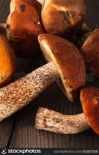 Orange-cap boletus mushrooms on the wooden table