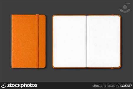 Orange closed and open notebooks mockup isolated on black. Orange closed and open notebooks isolated on black