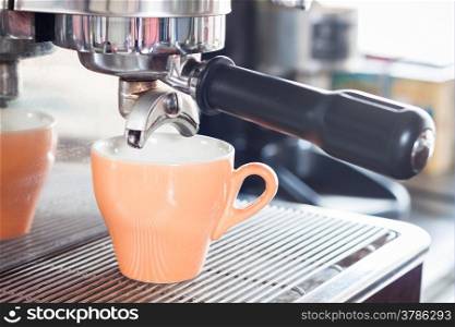 Orange coffe cup prepares for espresso, stock photo